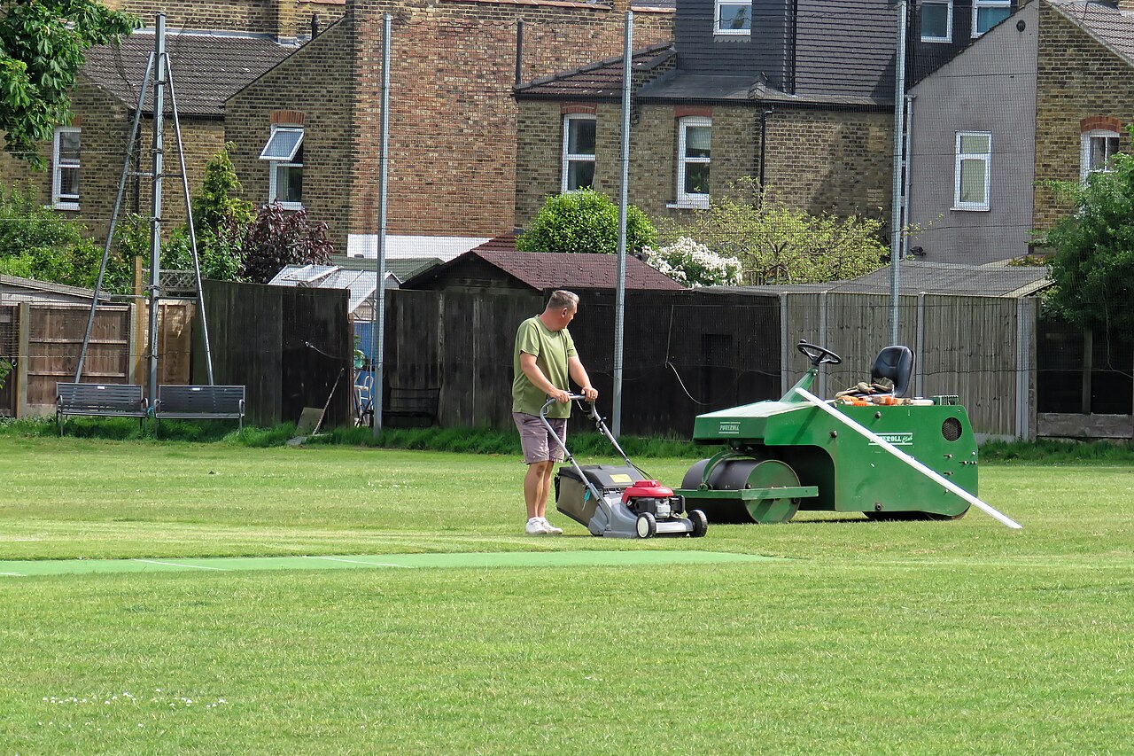 Groundstaff working on a relaid square under the covers before a match