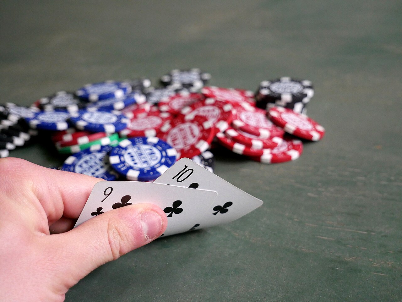 Community cards on the flop with a pot of chips pushed to the middle